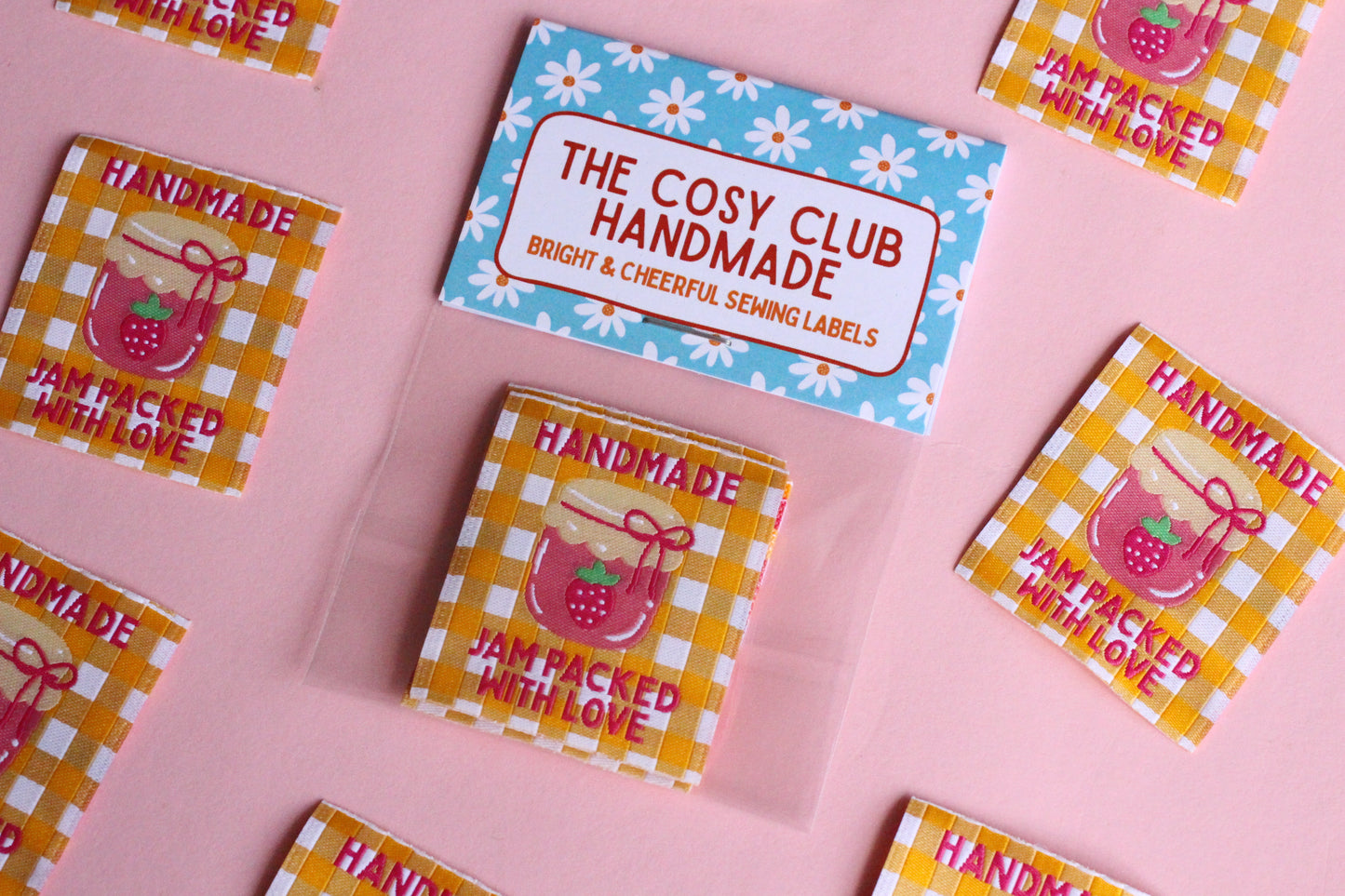 Handmade sewing labels featuring "Jam Packed With Love" by The Cosy Club Handmade, showcasing five charming, personalized fabric tags.