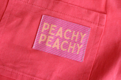 Large peach-colored woven sewing labels from The Cosy Club Handmade, featuring the Peachy Peach design for clothing and crafts.