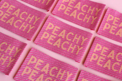 Large peach-colored woven sewing labels from The Cosy Club Handmade, featuring the Peachy Peach design on fabric.