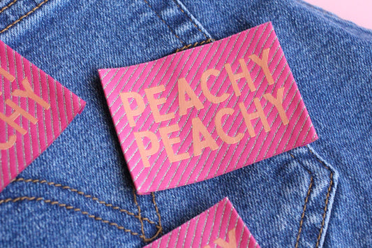 Large Peachy Peach woven sewing labels from The Cosy Club Handmade, featuring colorful, decorative fabric labels for sewing projects.