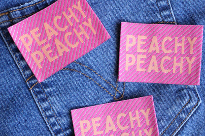 Large Peachy Peach woven sewing labels by The Cosy Club Handmade, showcasing colorful, textured fabric labels for sewing projects.
