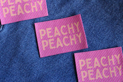 Peachy Peach large woven sewing labels by The Cosy Club Handmade, showing four fabric labels with embroidered text on a white background.