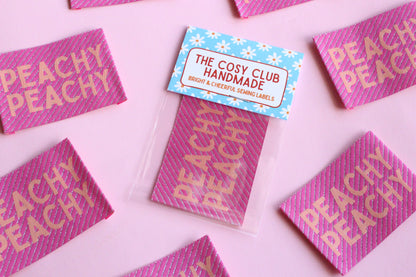 Large Peachy Peach sewing labels by The Cosy Club Handmade, woven fabric labels for custom clothing or craft projects.