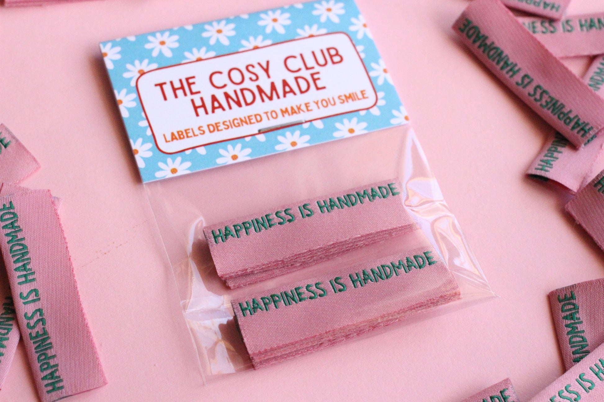 Six handmade fabric sewing labels from The Cosy Club Handmade, featuring side seam design for personalized garment finishing.