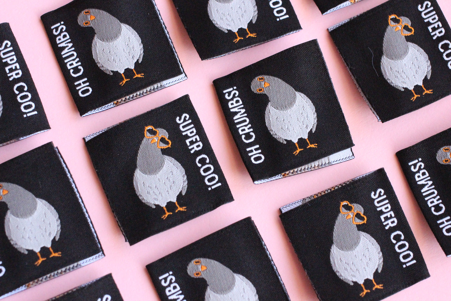 Six double-sided Pigeon sewing labels from The Cosy Club Handmade, featuring colorful bird designs on white fabric.