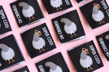 Six double-sided Pigeon sewing labels from The Cosy Club Handmade, featuring colorful bird designs on white fabric.