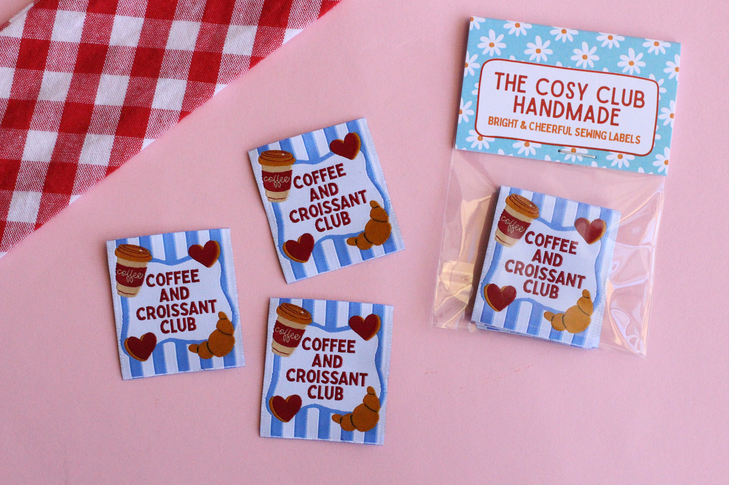 Set of five sewing labels from The Cosy Club Handmade featuring coffee cups and croissants for clothing or craft projects.