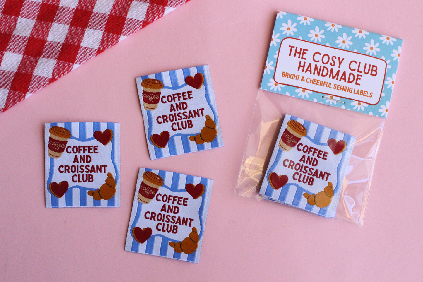 Set of five sewing labels featuring coffee and croissant designs from The Cosy Club Handmade, ideal for craft projects and clothing.