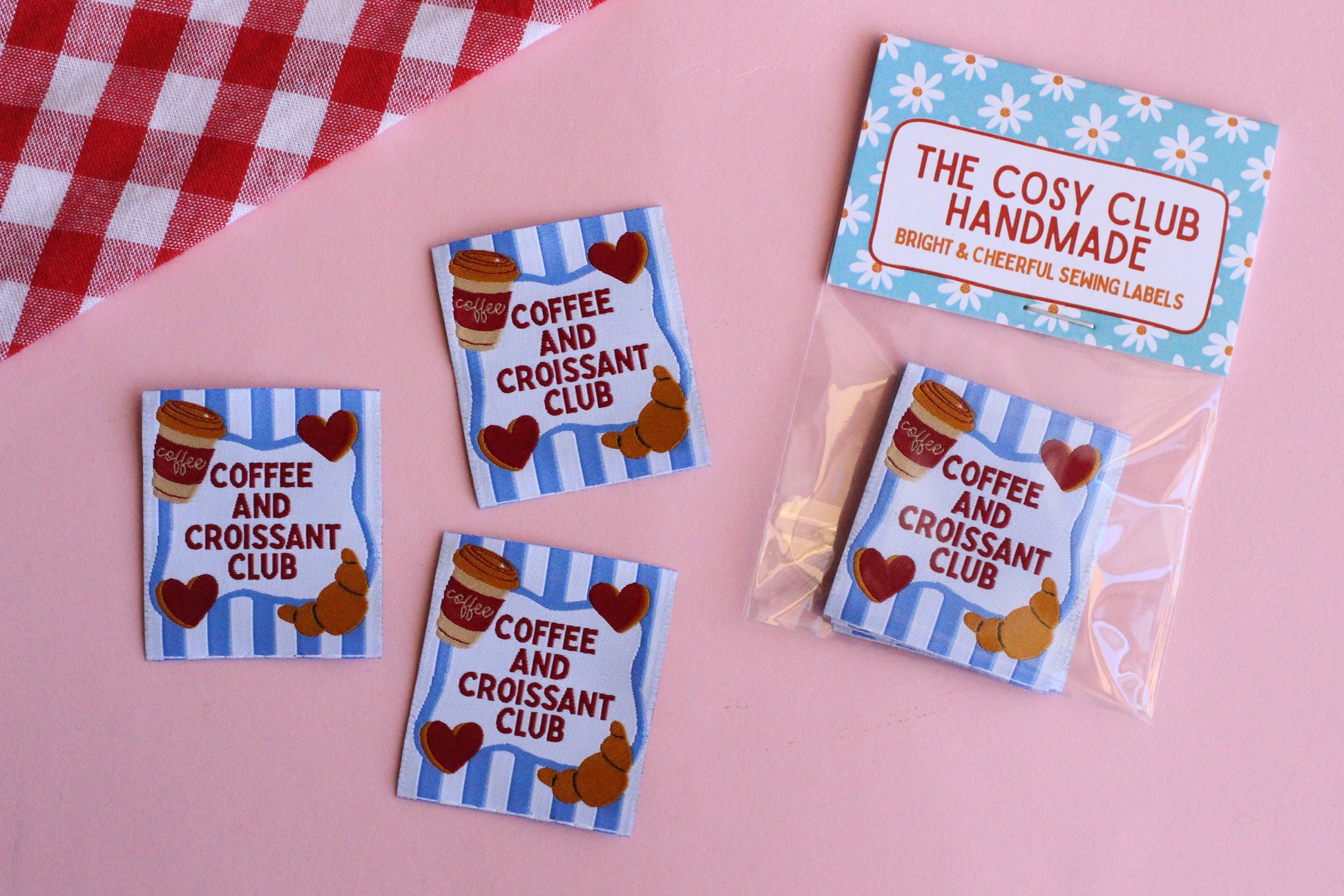 Set of five sewing labels featuring coffee and croissant designs from The Cosy Club Handmade, ideal for craft projects and clothing.