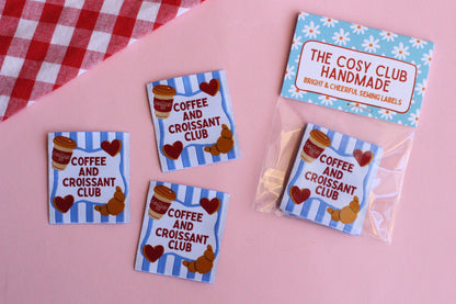 Set of five sewing labels featuring coffee and croissant designs from The Cosy Club Handmade, ideal for craft projects and clothing.