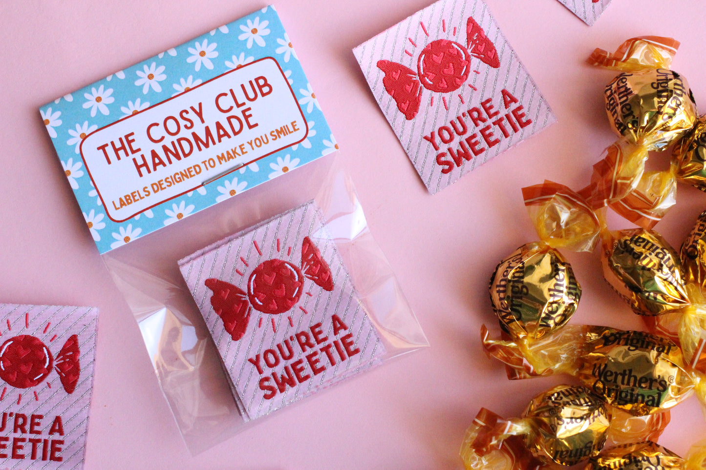 Colorful fabric sewing labels reading "You're a SWEETIE" by The Cosy Club Handmade, designed for craft and sewing projects.