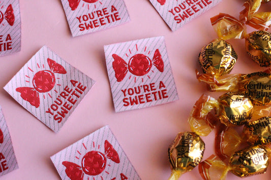 You're a SWEETIE candy sewing labels by The Cosy Club Handmade, featuring colorful paper labels with playful text for craft projects.