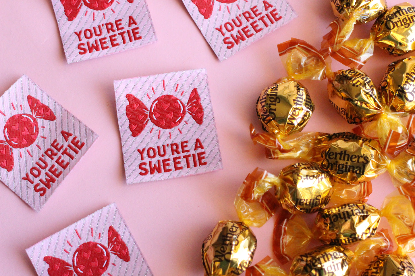 Five colorful "You're a SWEETIE" candy-themed sewing labels by The Cosy Club Handmade, featuring vibrant, playful designs.