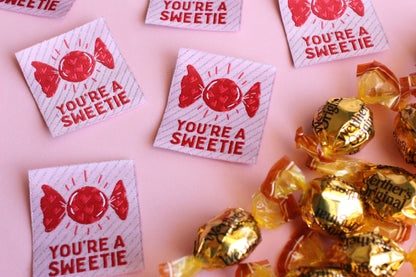 Five colorful "You're a SWEETIE" candy-themed sewing labels by The Cosy Club Handmade, featuring playful designs on fabric labels.