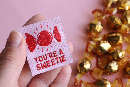 You're a SWEETIE candy sewing labels by The Cosy Club Handmade, showing colorful fabric labels with playful text and candy designs.