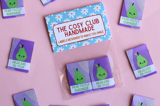 Six double-sided woven labels with PEAR-fectly handmade design from The Cosy Club Handmade, displayed on a neutral background.