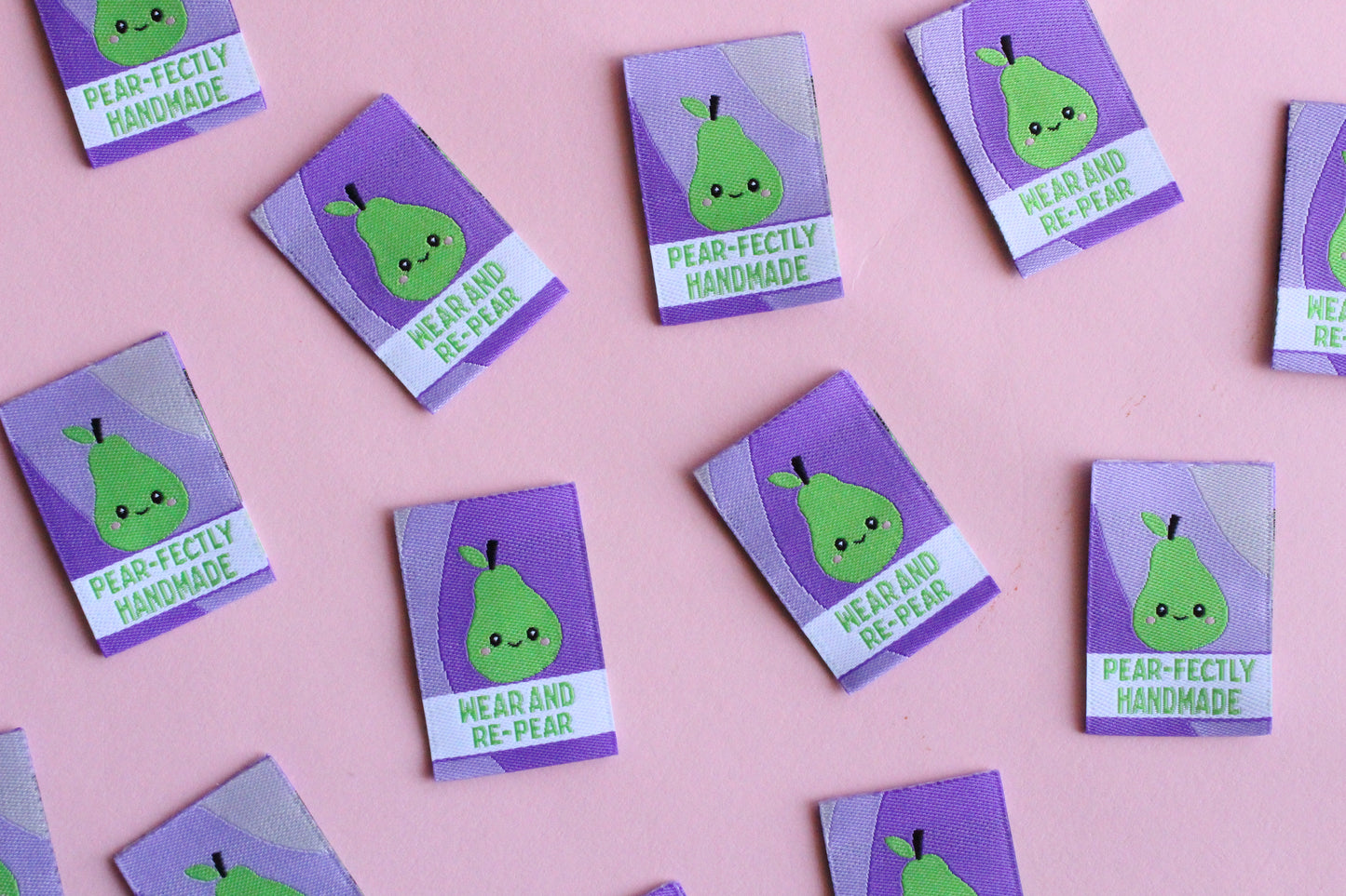 Six double-sided woven labels with PEAR-fectly Handmade branding, featuring intricate embroidery and vibrant colors.