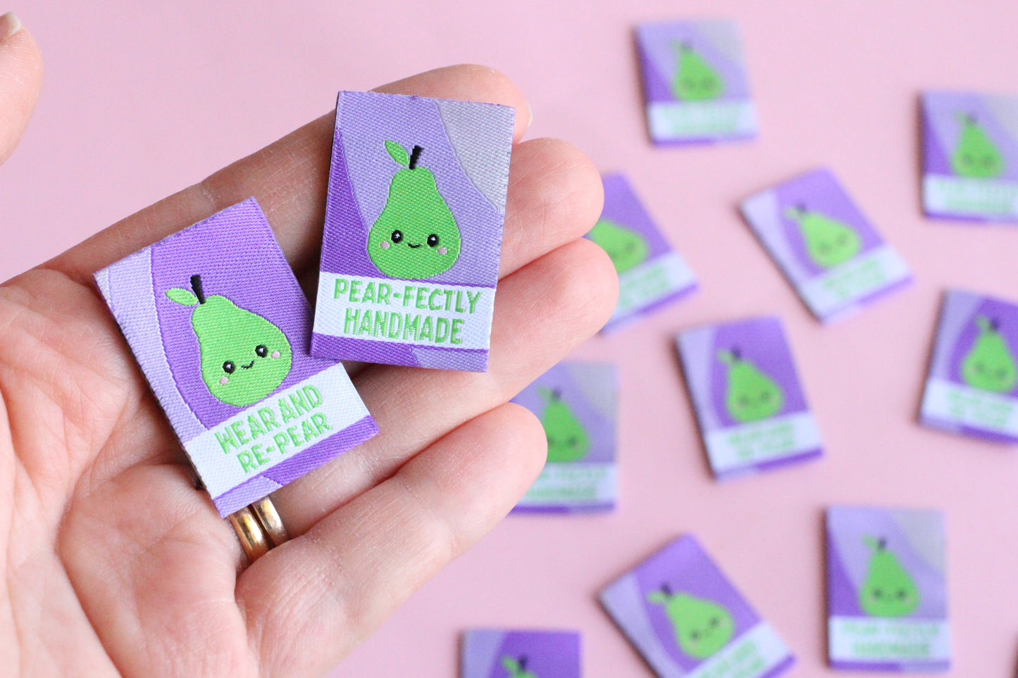 Six double-sided woven labels from PEAR-fectly Handmade by The Cosy Club Handmade displayed on a neutral background.