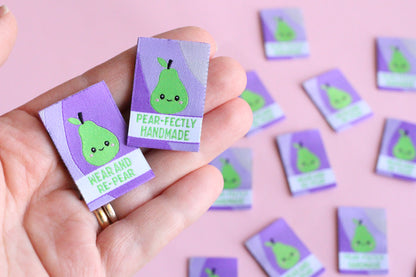 Six double-sided woven labels from PEAR-fectly Handmade by The Cosy Club Handmade displayed on a neutral background.
