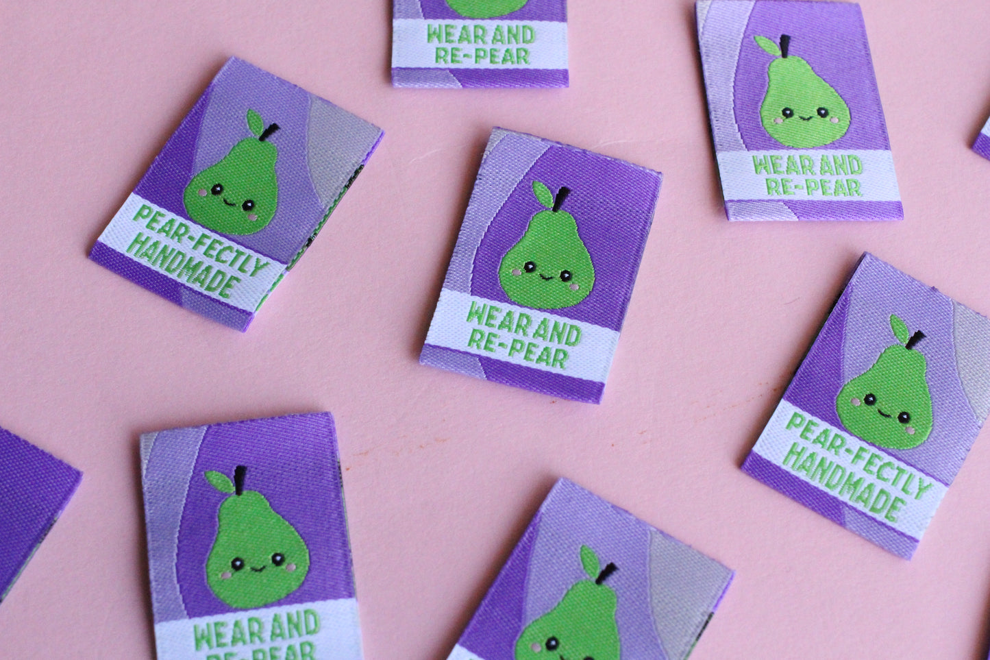 Six double-sided woven labels from PEAR-fectly Handmade by The Cosy Club Handmade, featuring intricate woven patterns.