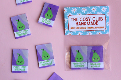 Six double-sided woven labels with "PEAR-fectly Handmade" design from The Cosy Club Handmade, showing detailed embroidery and texture.
