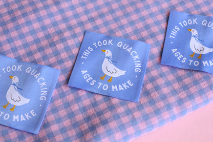 White goose sewing labels from The Cosy Club Handmade with "This Took Quacking Ages To Make" text, designed for fabric and craft projects.