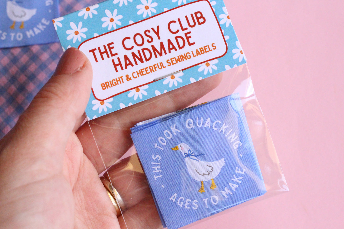 White goose sewing labels with "This Took Quacking Ages To Make" text from The Cosy Club Handmade, showcasing the detailed labels.