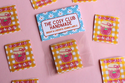 Set of five handmade sewing labels from The Cosy Club Handmade, jam-themed with "Packed With Love" design for craft projects.